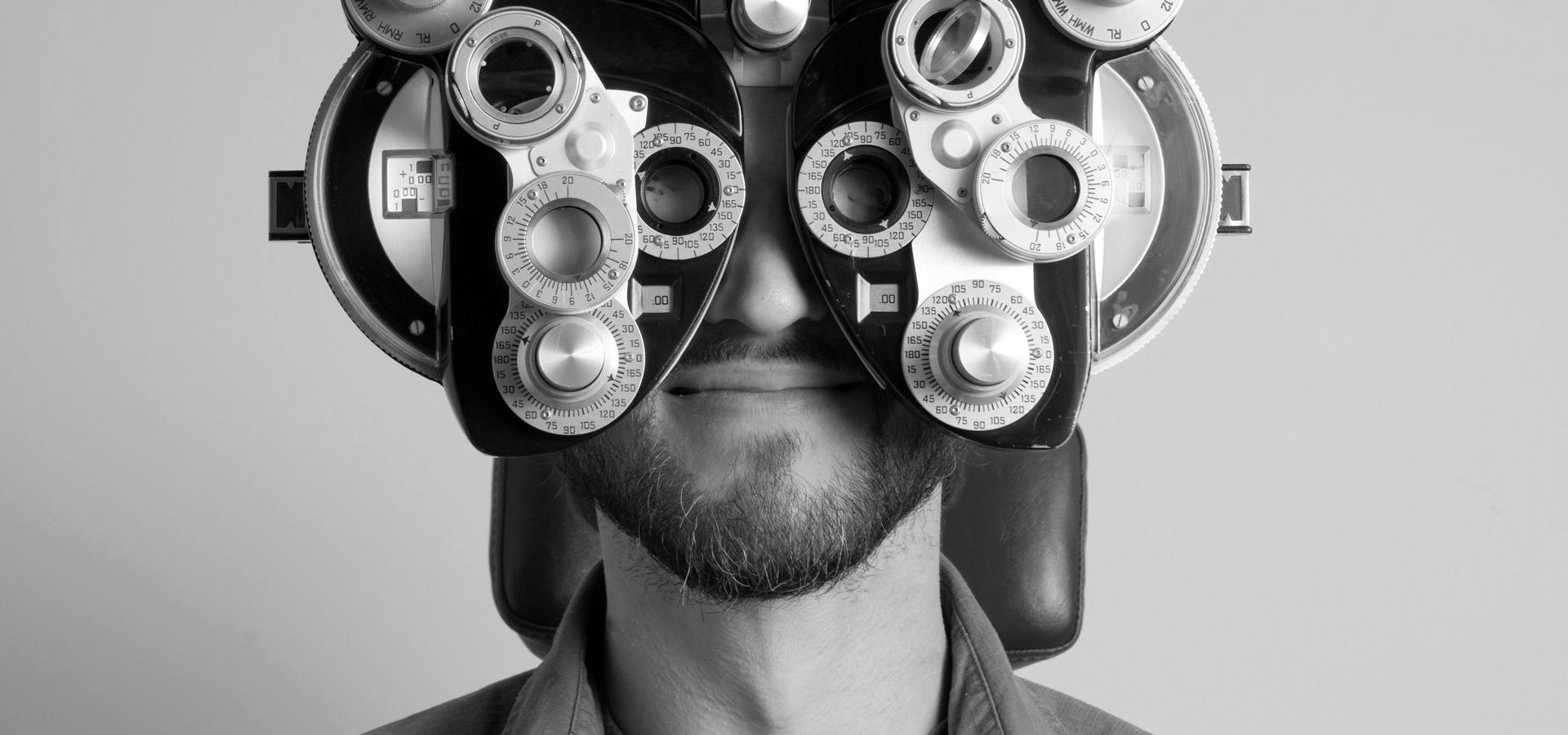 A man getting his eyes examined at the optometry office.